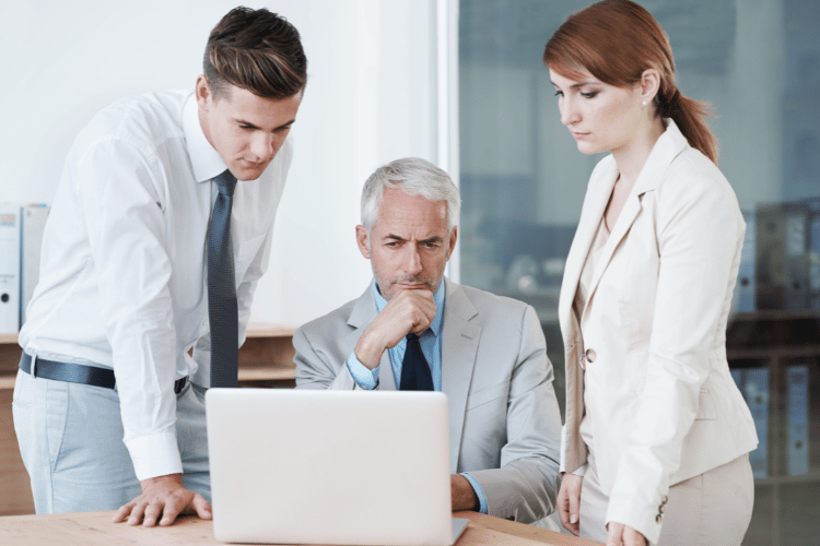 Person writing notes with coffee nearby